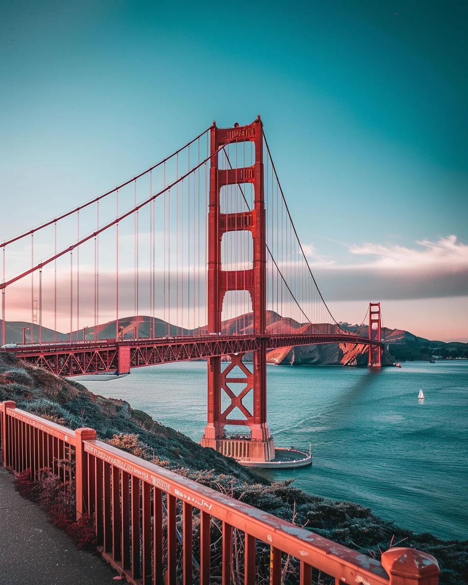 The Golden Gate Bridge during sunset with clear blue sky and water.