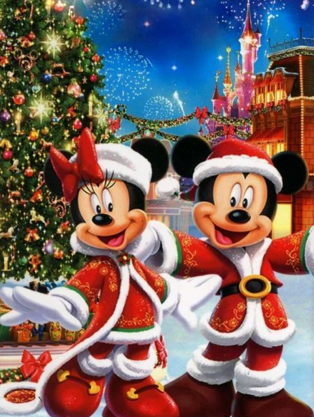 Mickey and Minnie Mouse in Christmas outfits with a decorated tree and castle in the background.