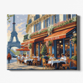 Painting of a Parisian street scene with a cafe and Eiffel Tower in the background.