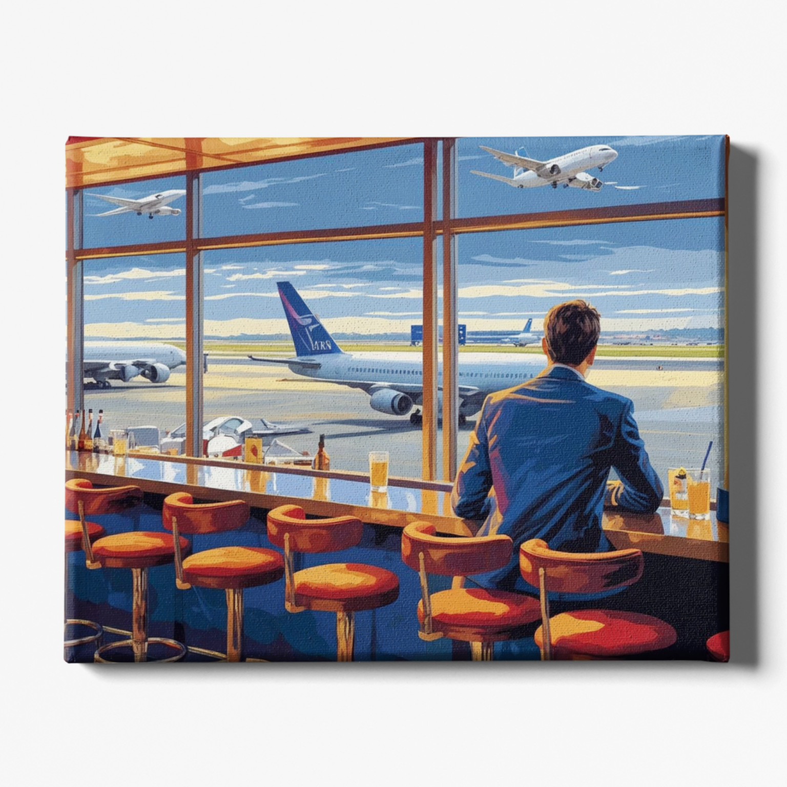 Man sitting at an airport bar looking out at airplanes