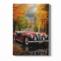 Vintage car on a scenic road with autumn trees and a castle-like building in the background